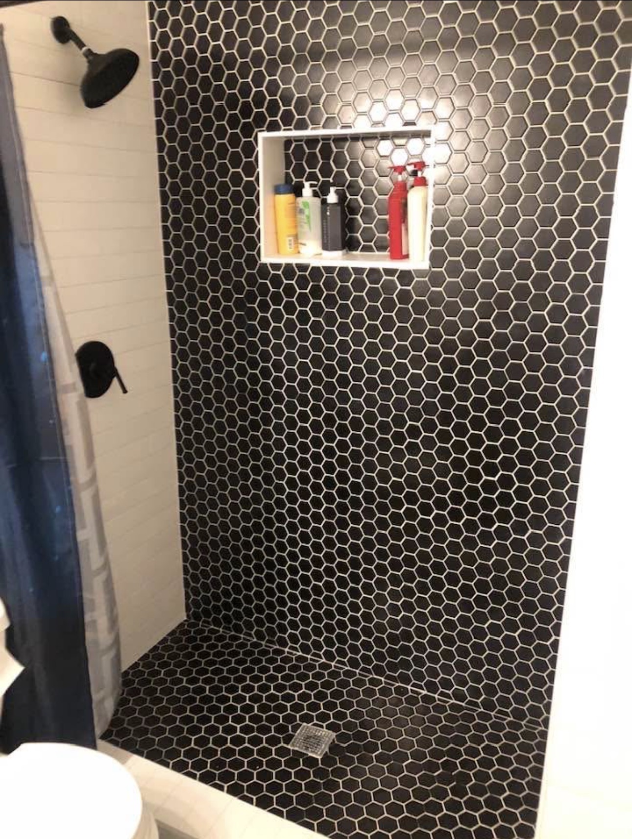 Gray subway tile shower with marble hexagon pan floor — bathroom remodel Fort Worth TX