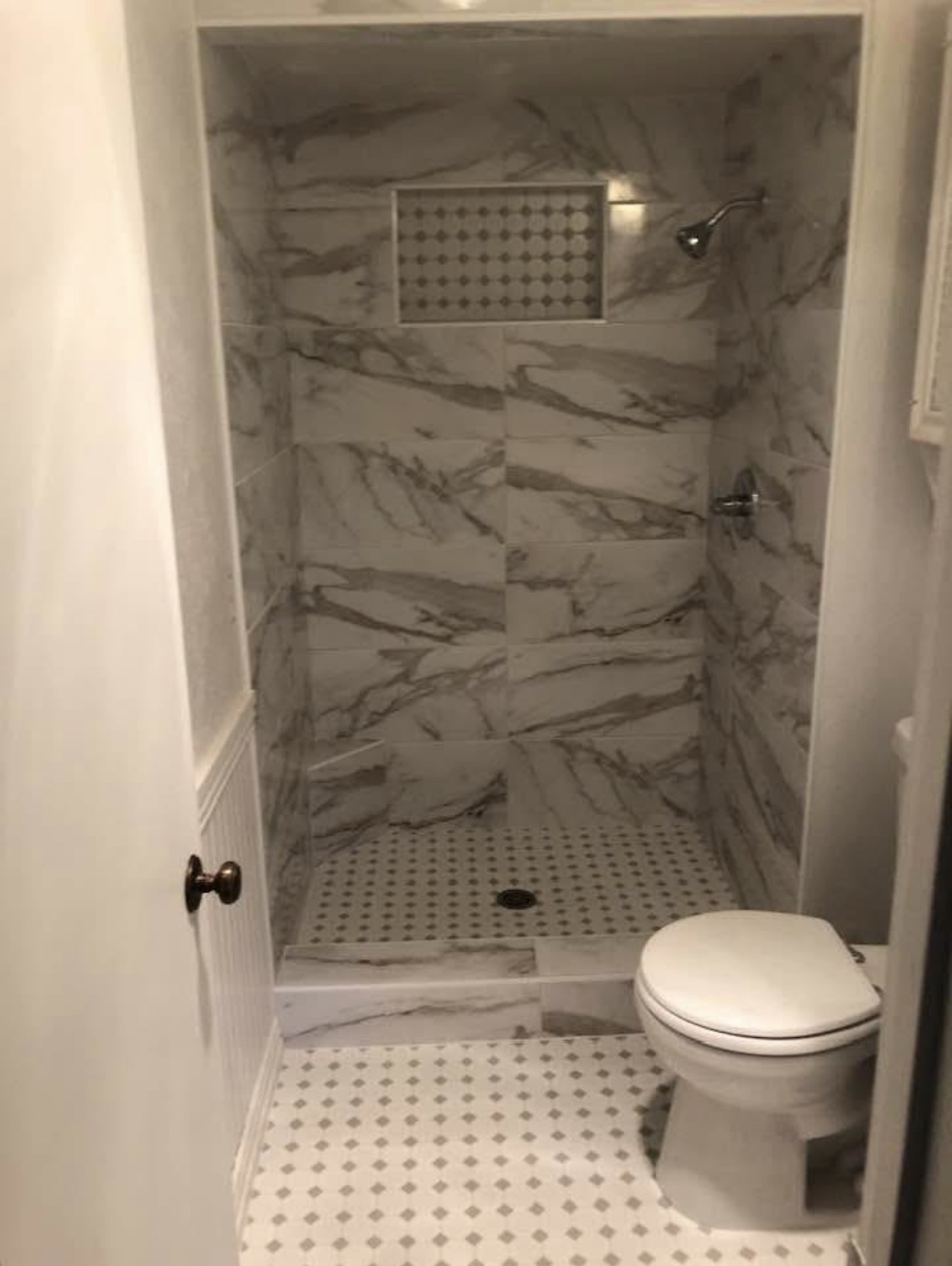 Dark charcoal shower tile with pebble stone floor — custom tile Irving TX