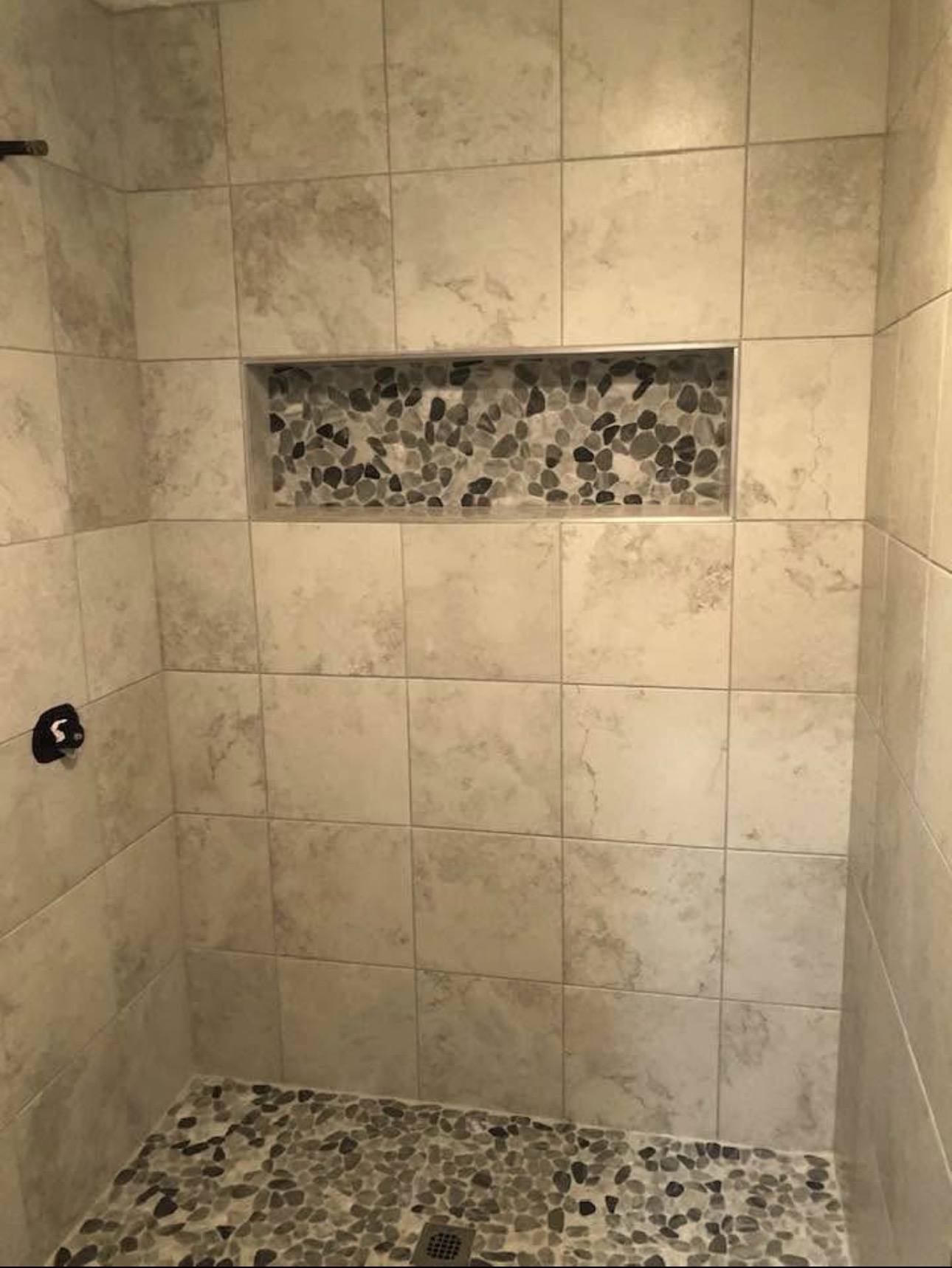 Dark geometric relief shower tile with built-in niche — custom tile contractor DFW